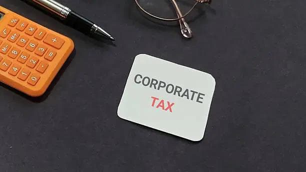 Corporate tax note on a desk with calculator, pen and glasses, symbolizing business tax filing and compliancedone with ese by timber accounting service